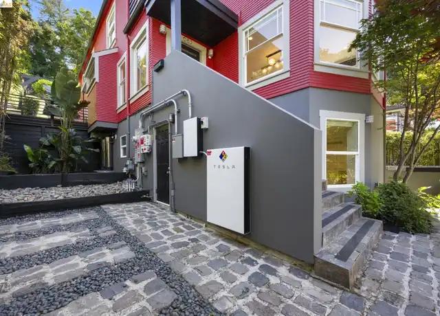 Wall-mounted battery at a multi-unit property